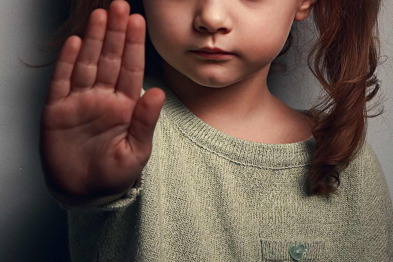 Angry kid girl showing hand signaling to stop - Startlap