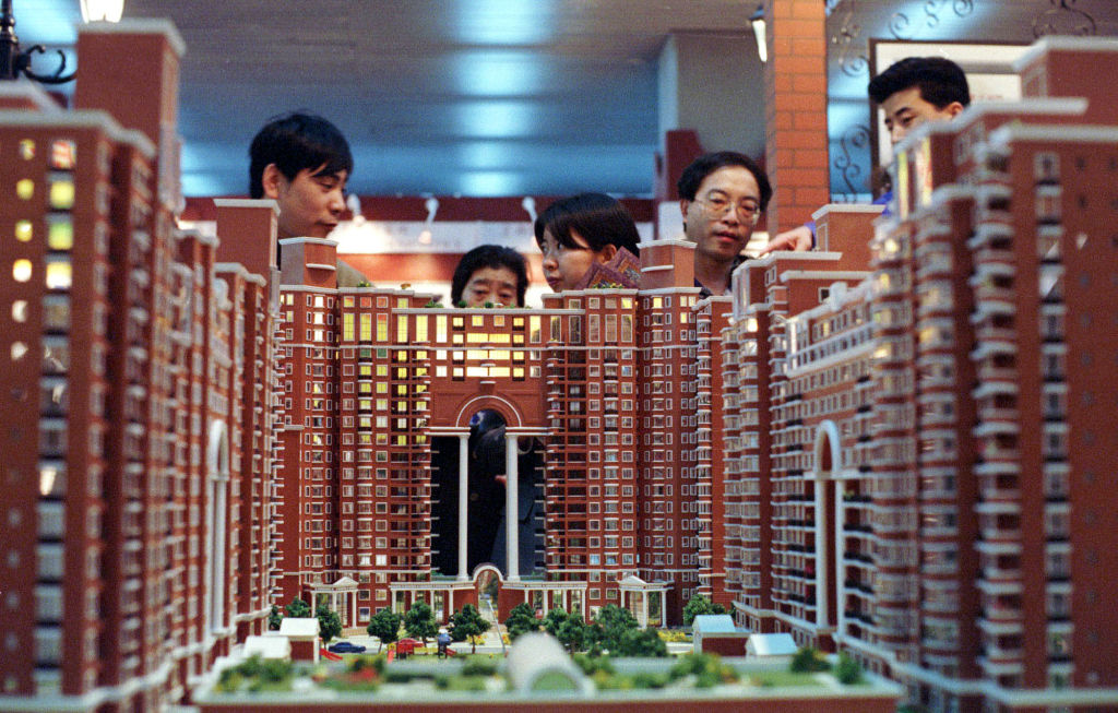 Attendants Look At The Miniature Of A Condominium On Display At A Sales Booth During A Ma - Startlap