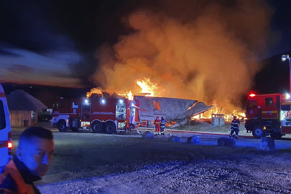 A Prahova megyei katasztrófavédelmi felügyelőség (ISU Prahova) által köreadott képen tűzoltók küzdenek a lángokkal egy kigyulladt panziónál a dél-romániai Tohani településen 2023. december 26-án.