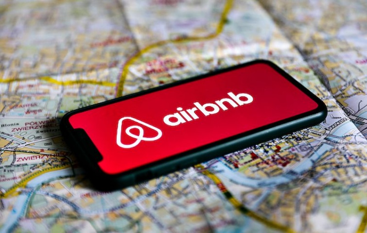 Az Airbnb alkalmazás logója egy mobil képernyőjén egy térkép felett