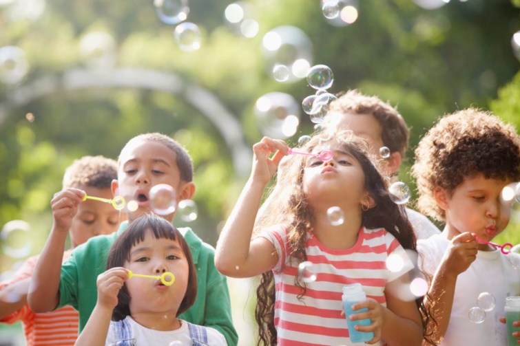 Gyerekek a szabadban buborékokat fújnak 