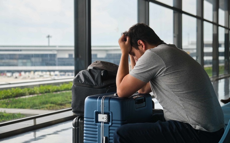 Frustrated man at the airport annoyed because his flight was canceled - Startlap Utazás
