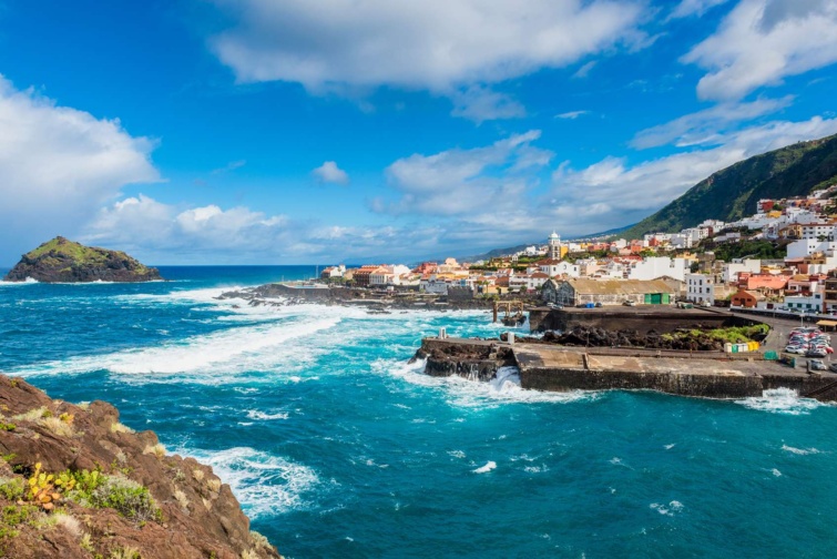 tenerife sziget_11zon - Startlap Utazás hullámok egy sziget mellett háttérben színes házak