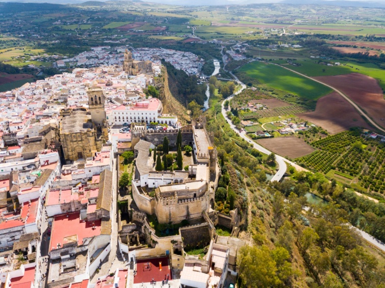 spanyol-varkastely - Startlap Utazás Légifelvétel a spanyolországi Arcos de la Frontera városában található középkori erődített várról, amely a Guadalete folyó partján húzódó homokkőgerincen magasodik.