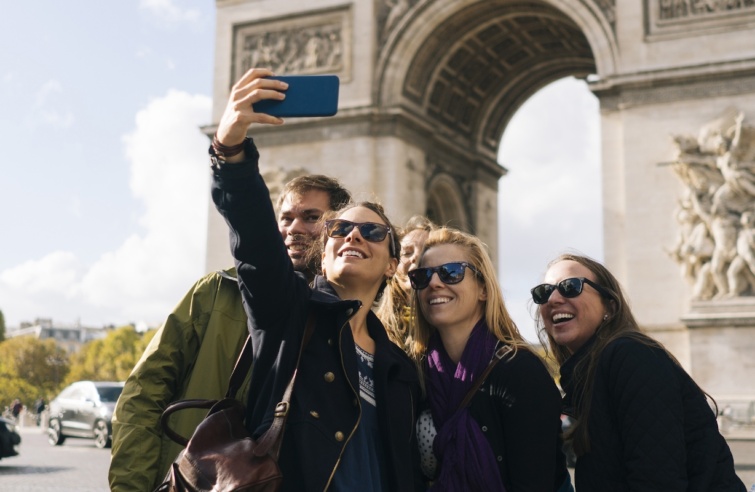 A párizsi Diadalív előtt fotózkodó turisták