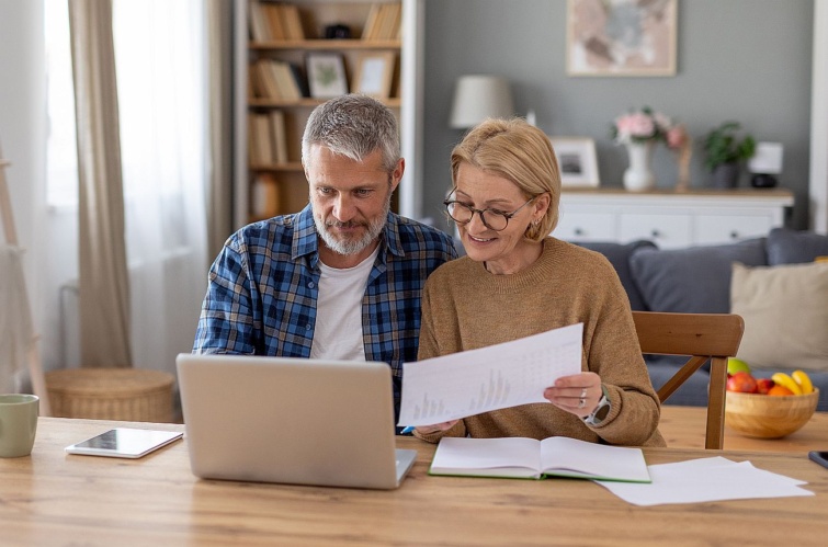 Couple Reviewing Documents Together at Home Office Startlap Vásárlás