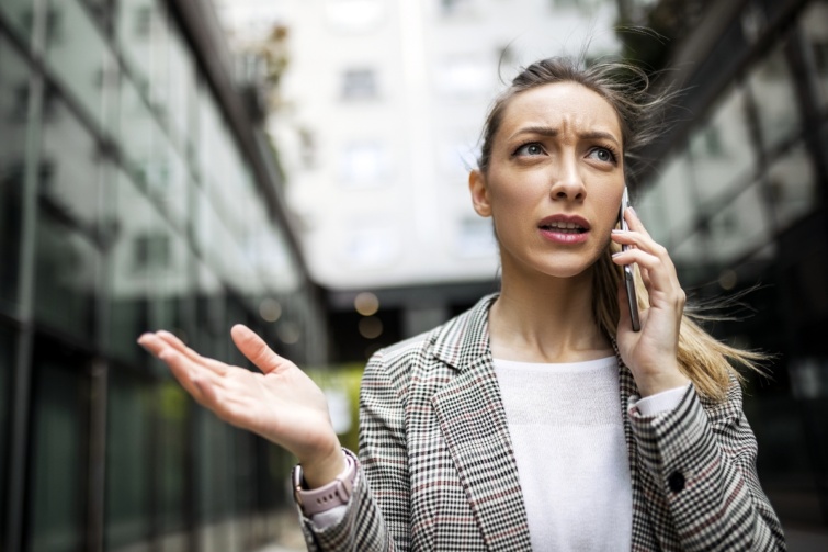 nomergestelefonal Startlap Vásárlás Fiatal nő mérgesen, kezével gesztikulálva telefonál
