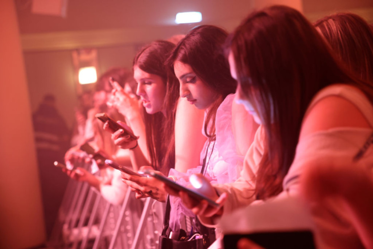 A rajongók mobiltelefonjaikat használják, miközben Madison Beer fellépésére várnak a berlini Metropolban 2022. április 23-án, Berlinben, Németországban. 